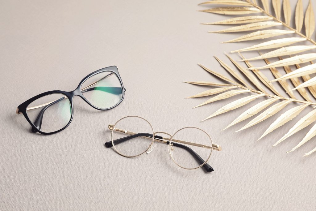 Stylish eyeglasses over pastel background. Optical store, glasses selection, eye test, vision